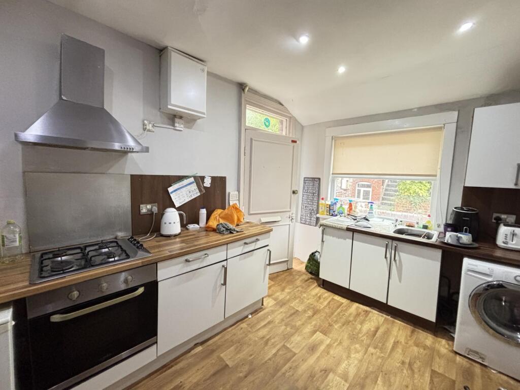 Bright and well-maintained kitchen with ample n...