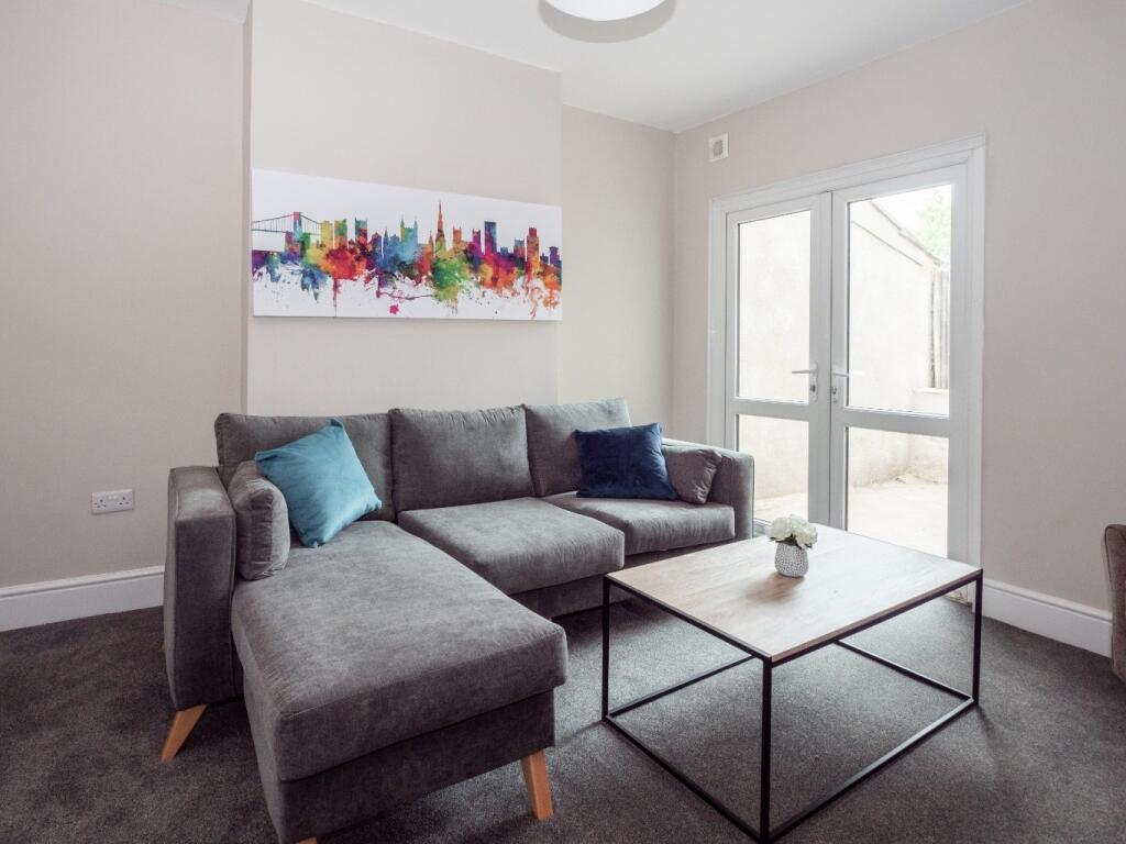 A cozy and modern living room featuring a comfo...