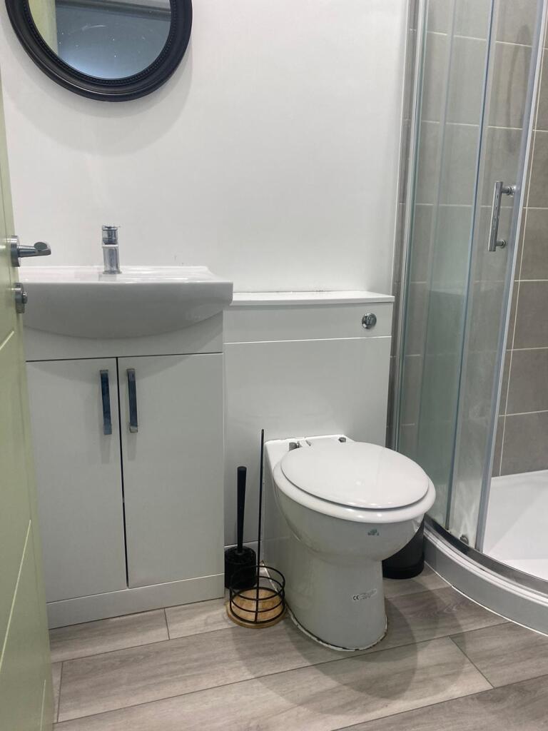 Modern and clean bathroom with a white vanity, ...