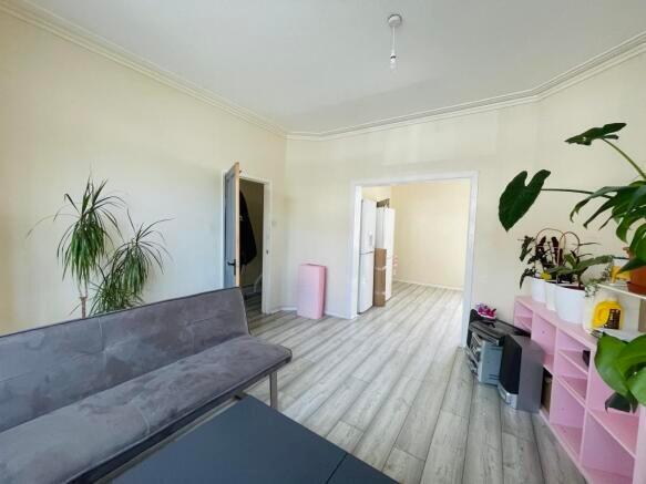 Bright and airy living room featuring light woo...