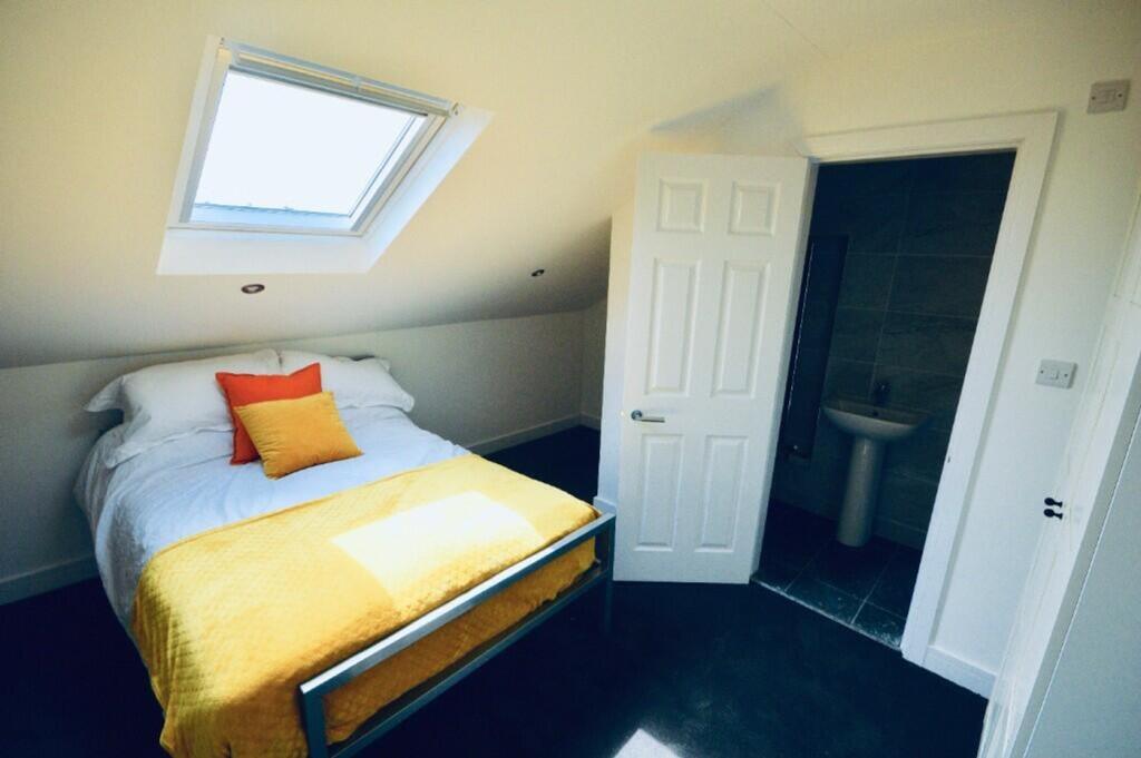 A bright and inviting double bedroom featuring ...