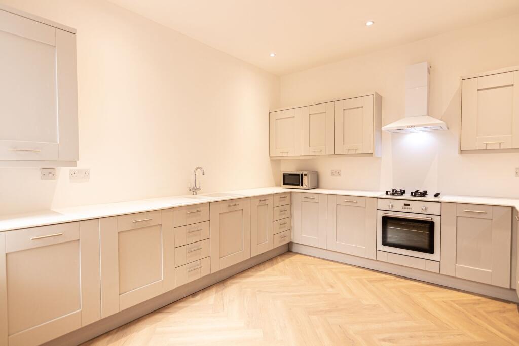 Modern and bright kitchen with ample cabinet st...