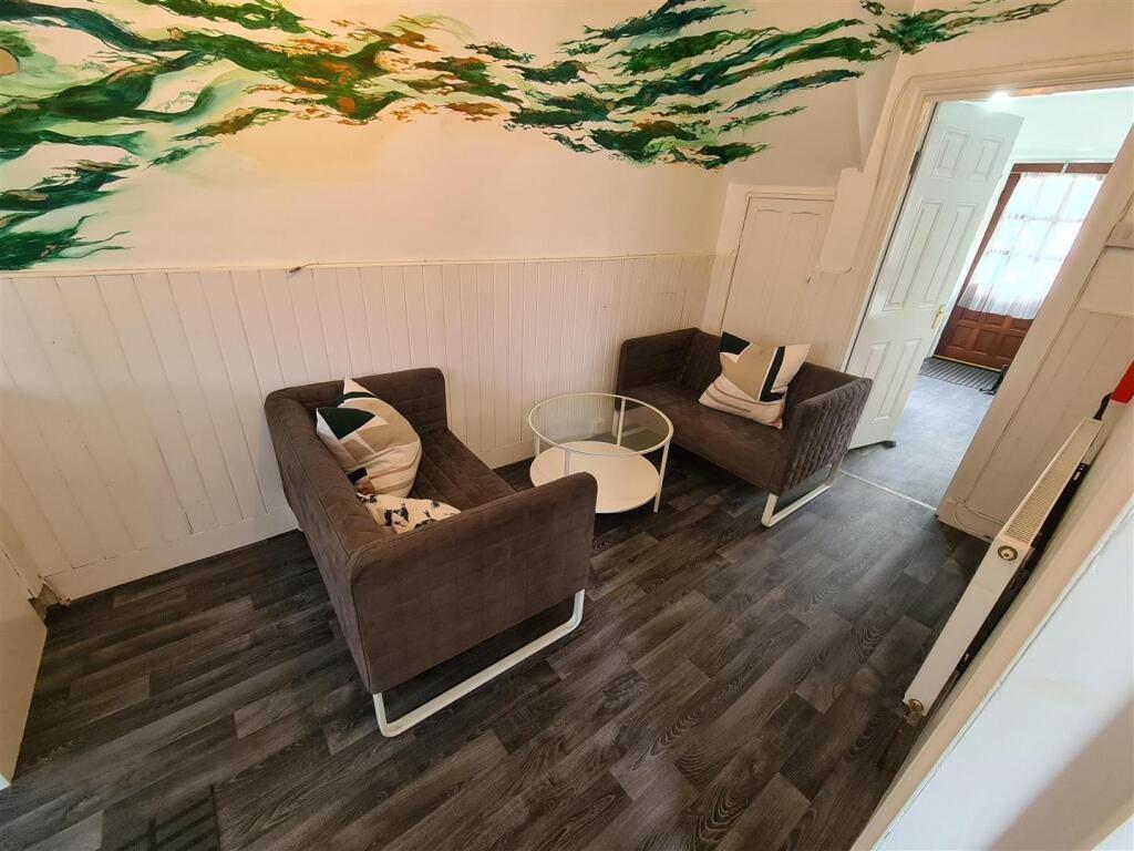 A cozy communal lounge featuring modern seating...
