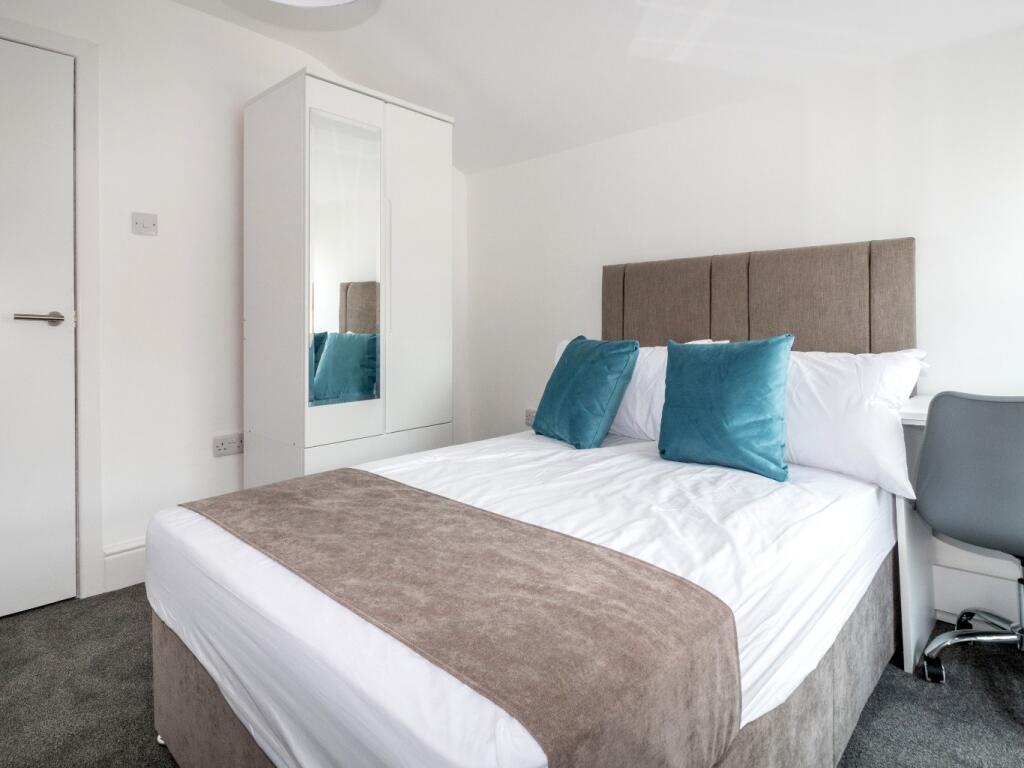 Bright and cozy double bedroom featuring a comf...