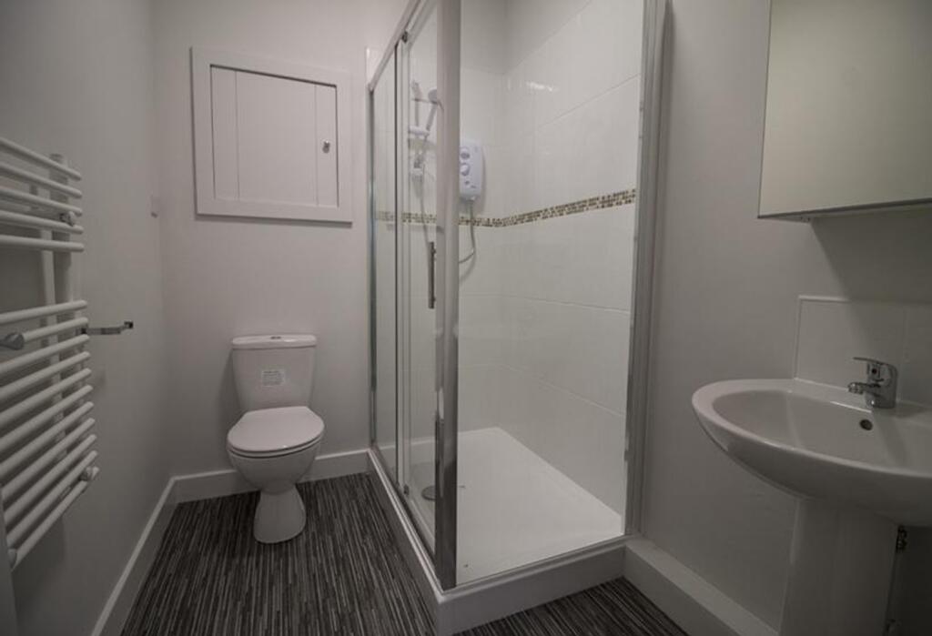 Bright and modern bathroom featuring a spacious...