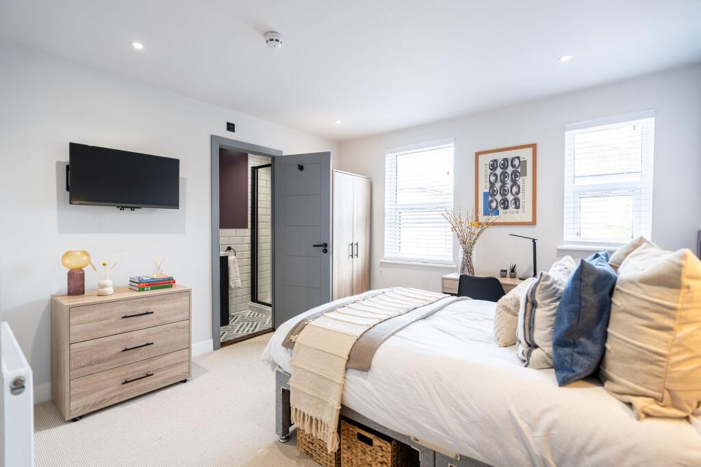 Bright and spacious master bedroom featuring a ...