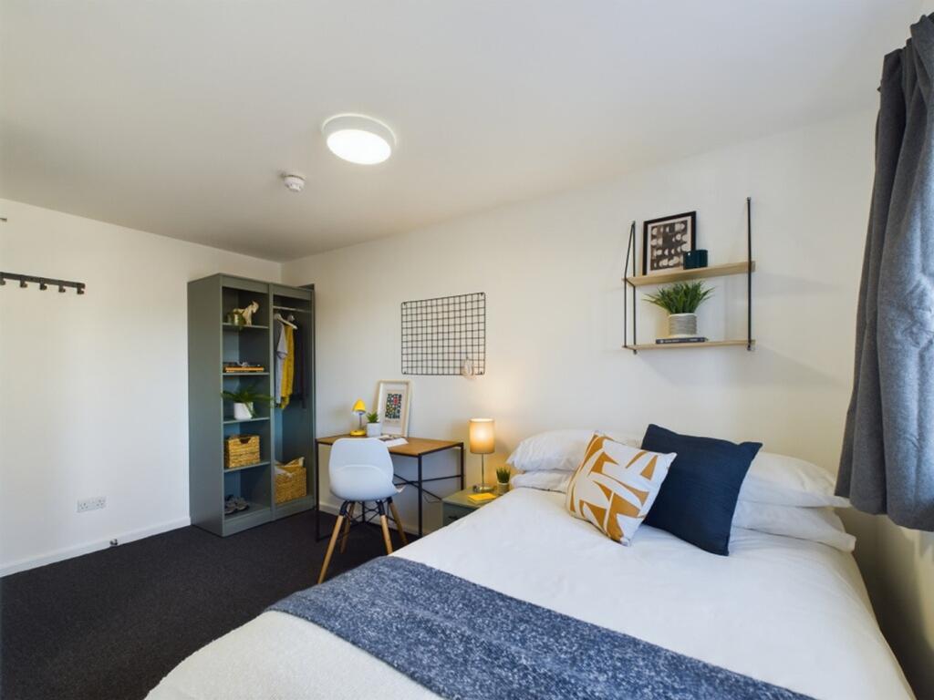 A spacious and well-decorated double bedroom, p...