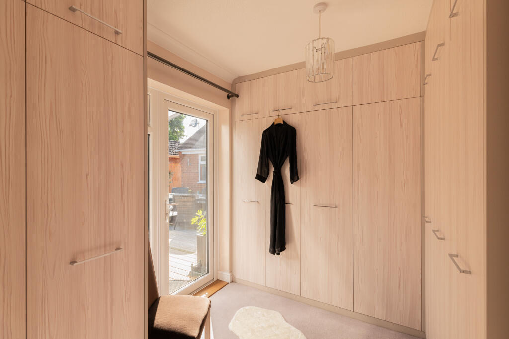 Principle dressing room leading to hot tub area through patio door