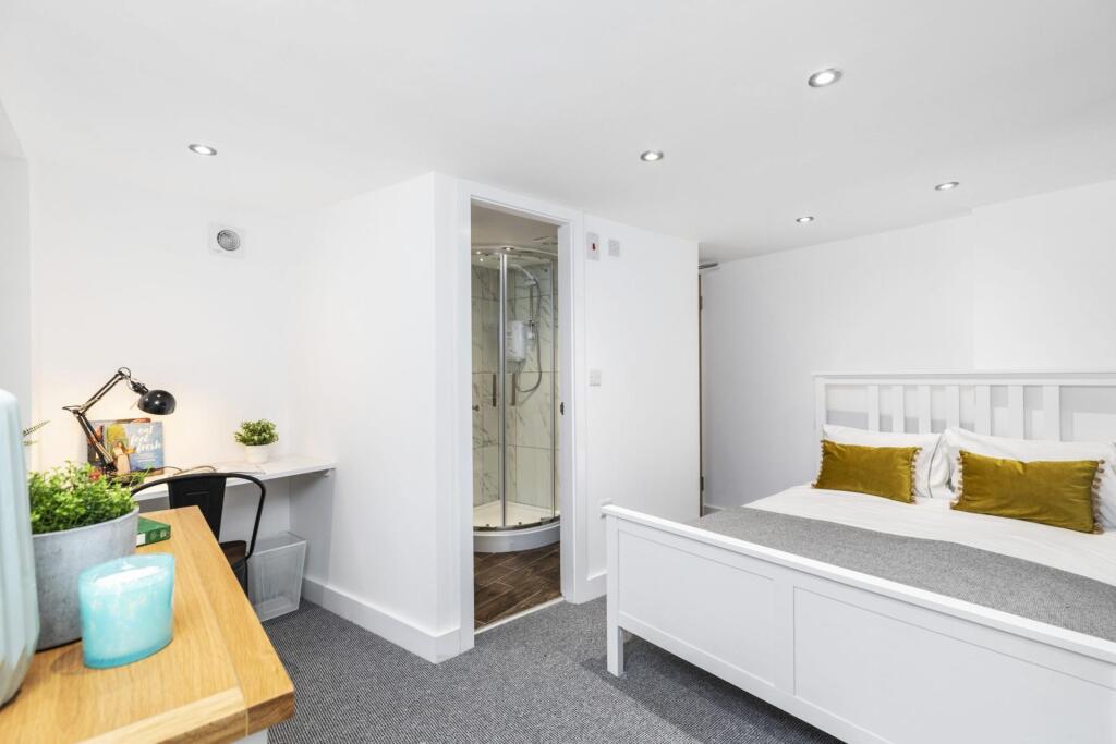 Bright, freshly decorated bedroom with a white ...