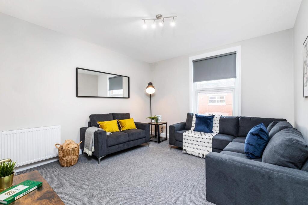 Bright, modern living room with two comfortable...