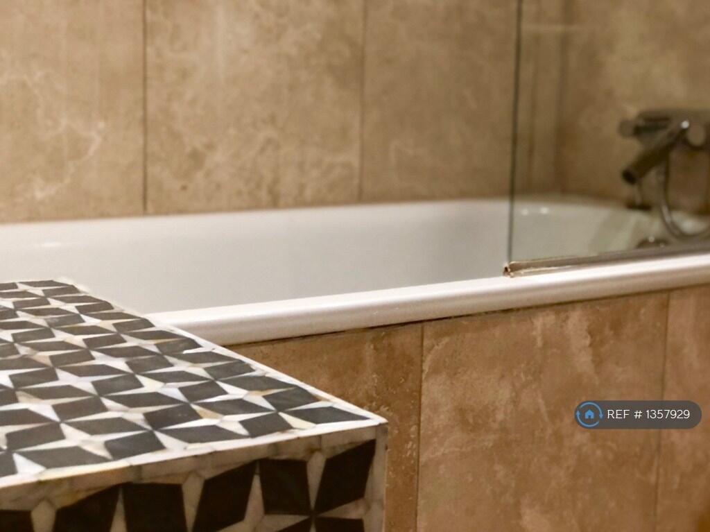 Bath With Overhead Shower. Shell Mosaic Cupboard