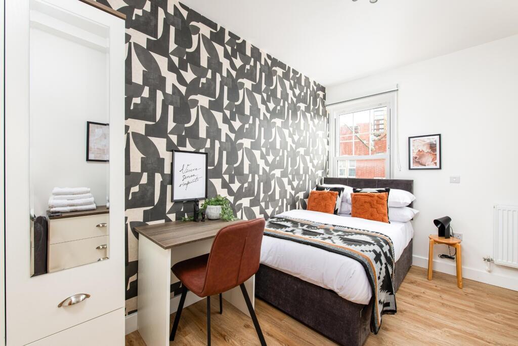 Bright and stylish double bedroom featuring a c...