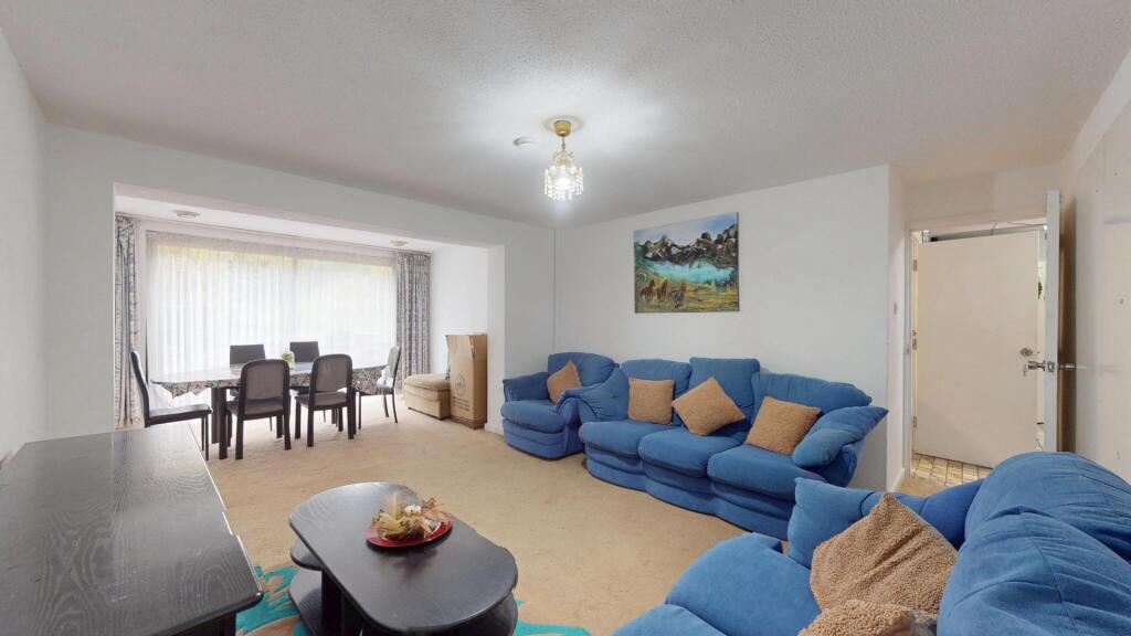 Bright and spacious living room featuring large...