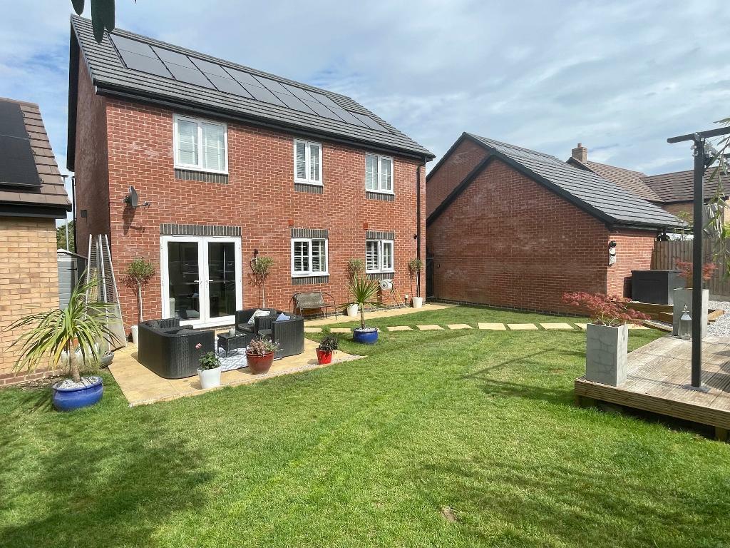 Rear lawn, patio and raised terrace