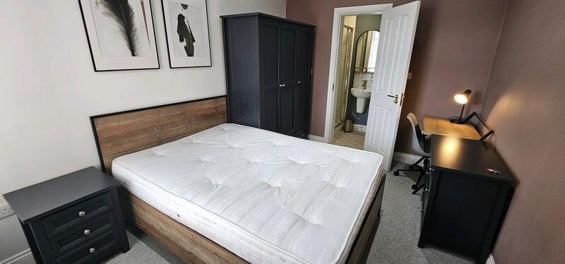 A modern master bedroom with a comfortable doub...