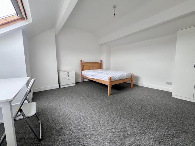 A spacious and bright master bedroom featuring ...