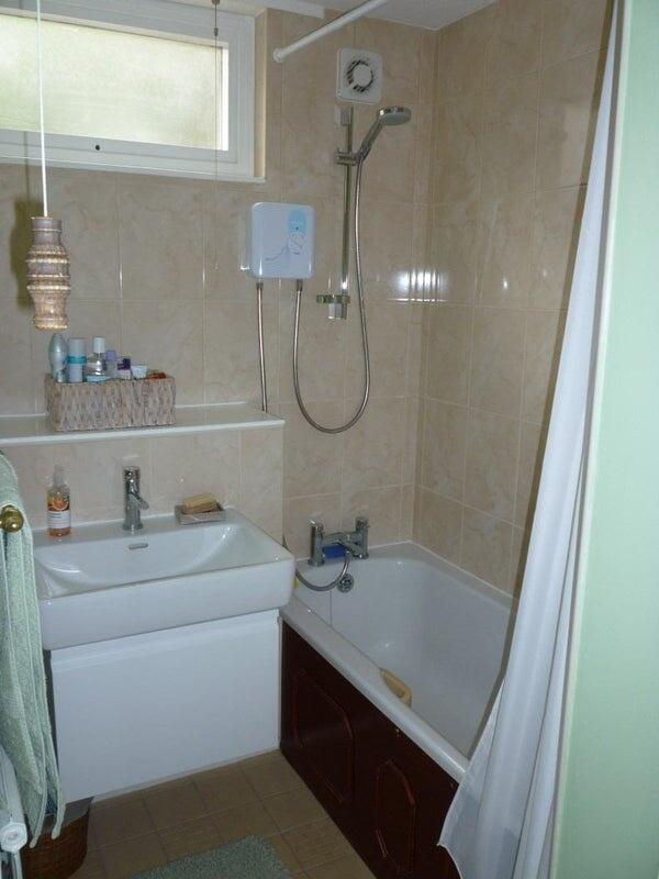 A well-maintained bathroom featuring a bathtub,...
