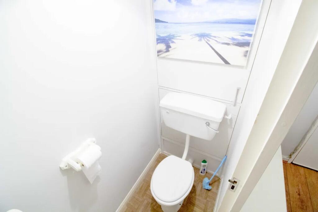 Bright and clean single toilet room with white ...