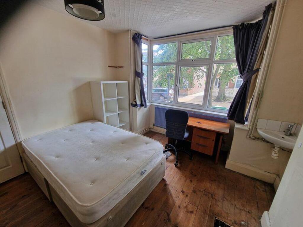 A bright and spacious double bedroom featuring ...