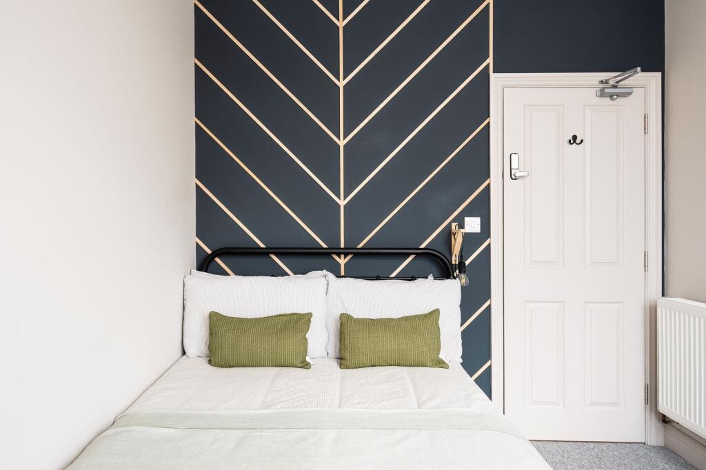 Bright, stylish bedroom with a modern patterned...