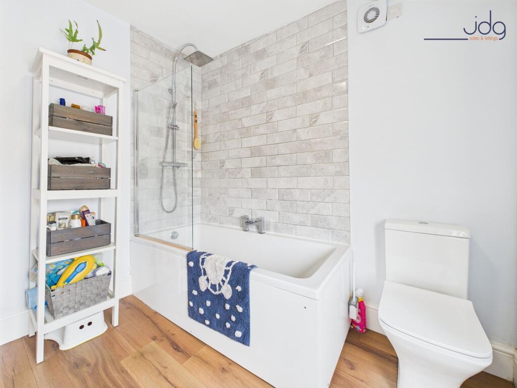 Modern three-piece suite and wood-effect vinyl flooring