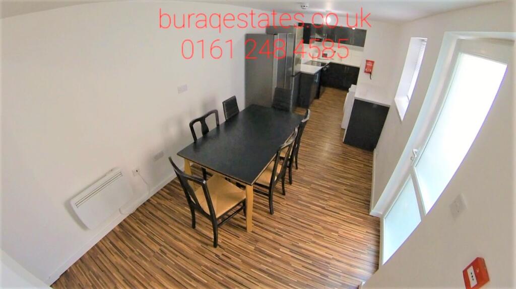 A modern kitchen and dining area with a sleek b...