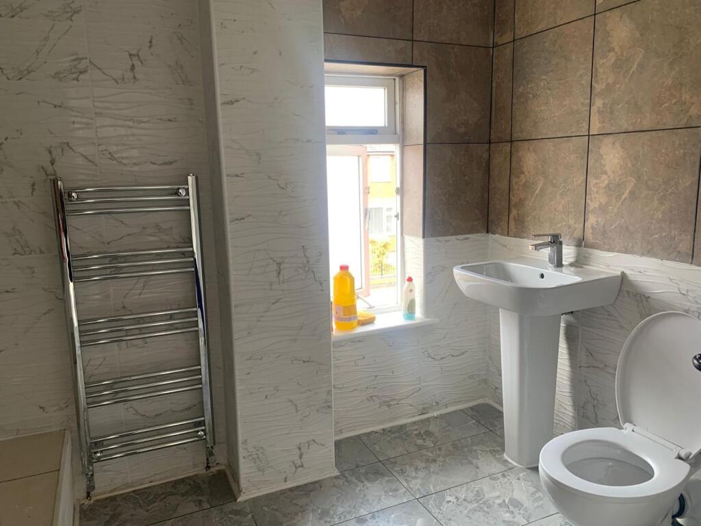 A bright and clean bathroom featuring modern ti...