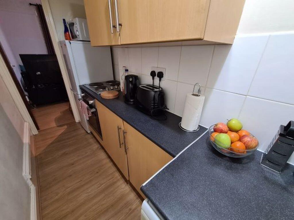 A clean and well-lit kitchen area featuring a m...