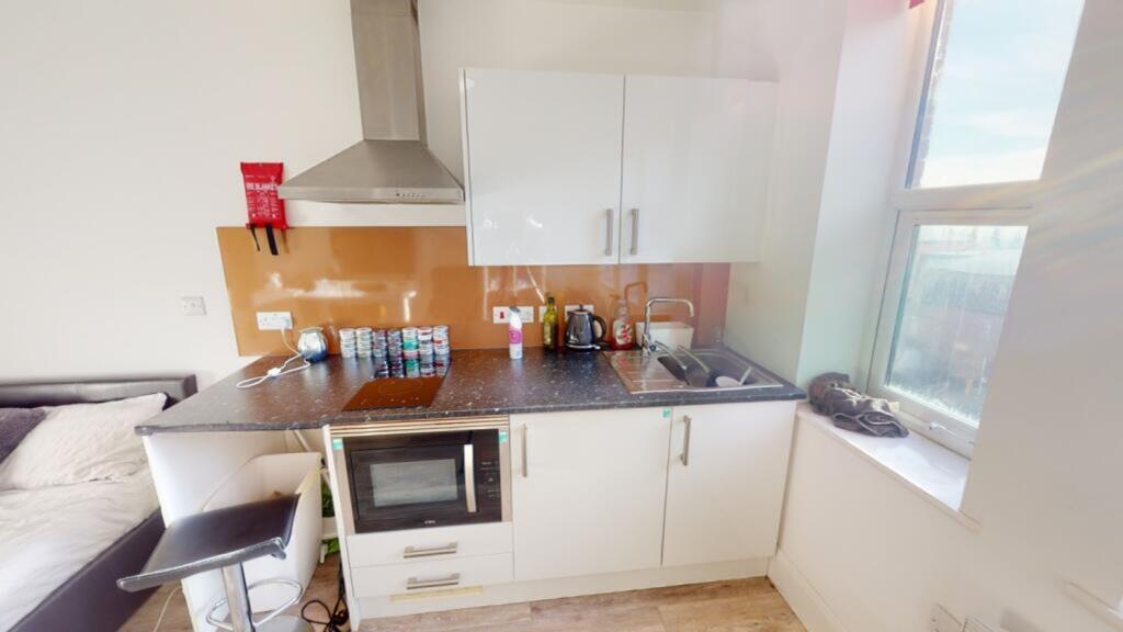 This modern kitchen features a sleek design wit...