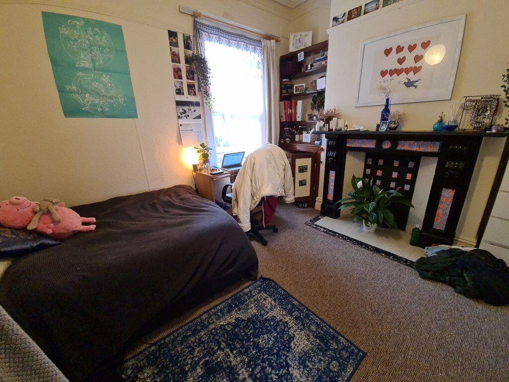 A cozy bedroom featuring a double bed, a study ...