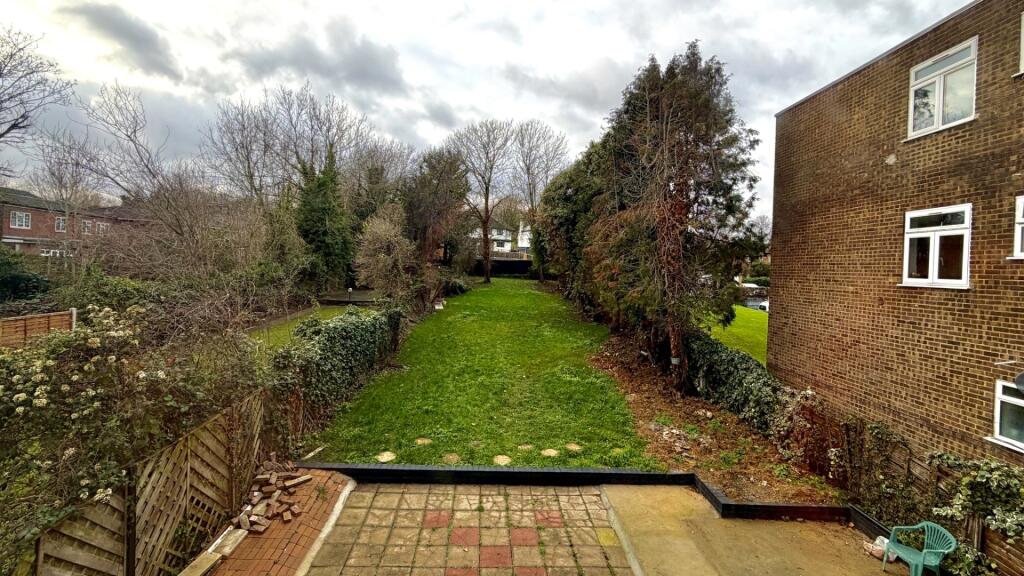 Well-maintained private rear garden with a pave...