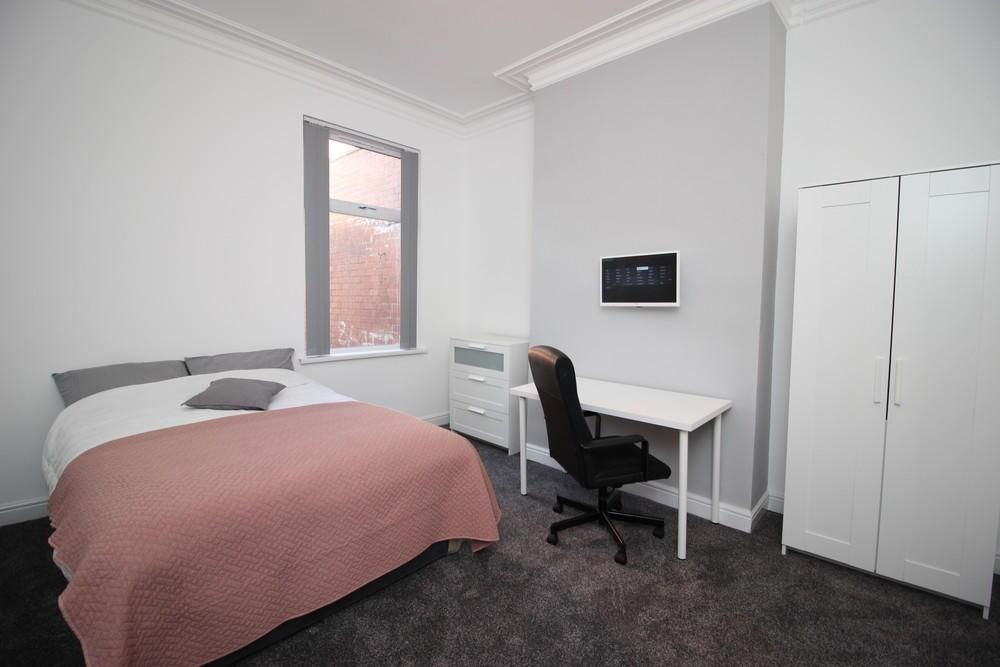 Bright and tidy double bedroom featuring a comf...