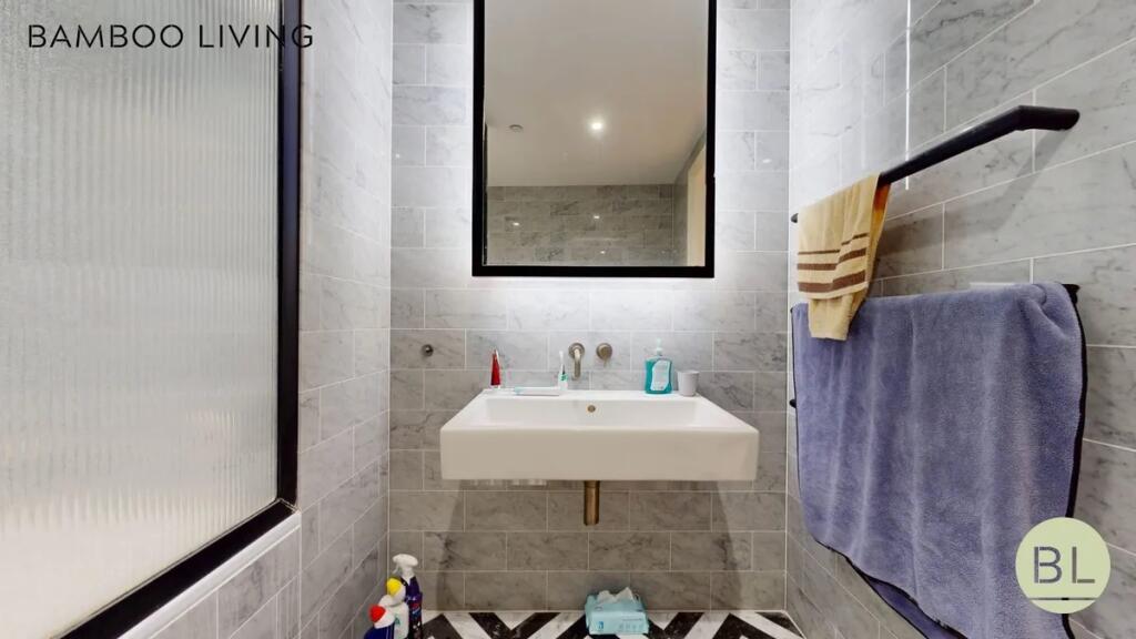 A modern bathroom featuring sleek gray marble t...