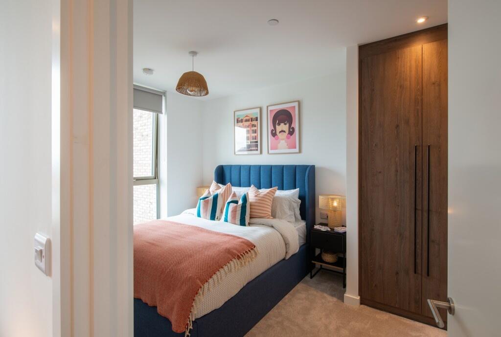 A cozy double bedroom featuring a stylish blue ...