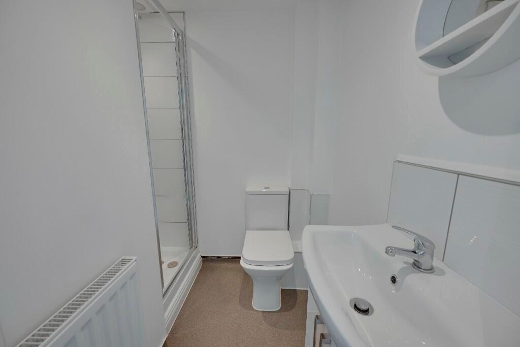 A clean and modern bathroom featuring a white s...