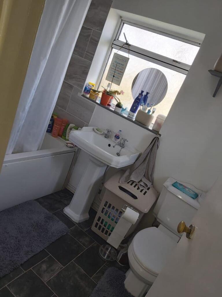 Bright and tidy bathroom featuring a modern sin...