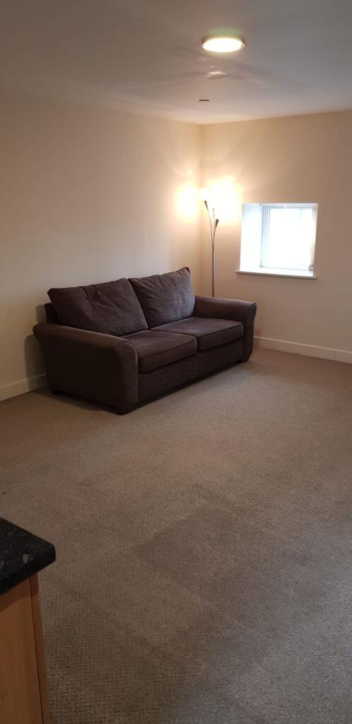 A neat and comfortable living room featuring a ...