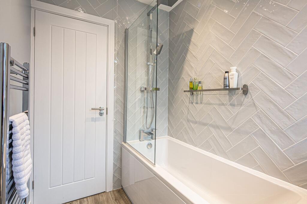 Modern bathroom with a spacious bathtub, sleek ...