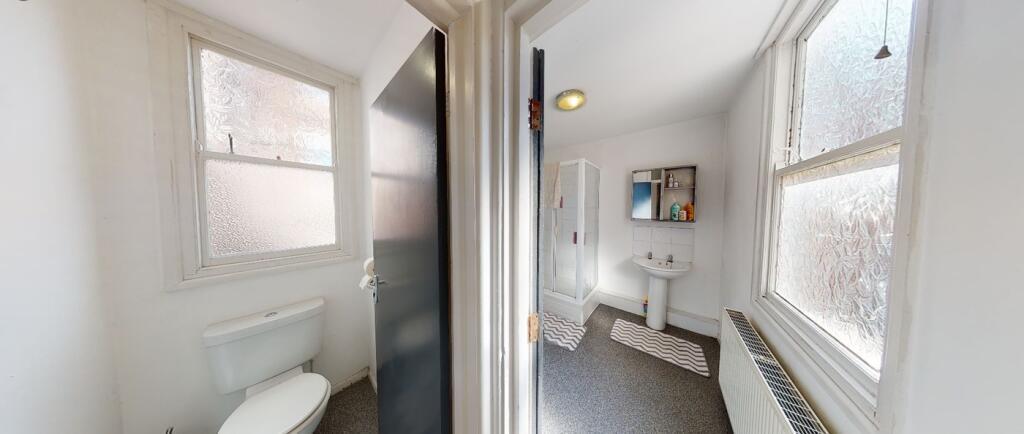 A bright and tidy bathroom featuring modern fix...