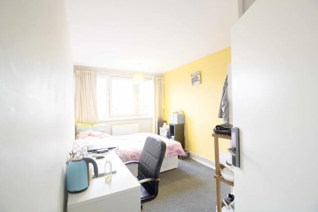 Bright single bedroom featuring a comfortable b...