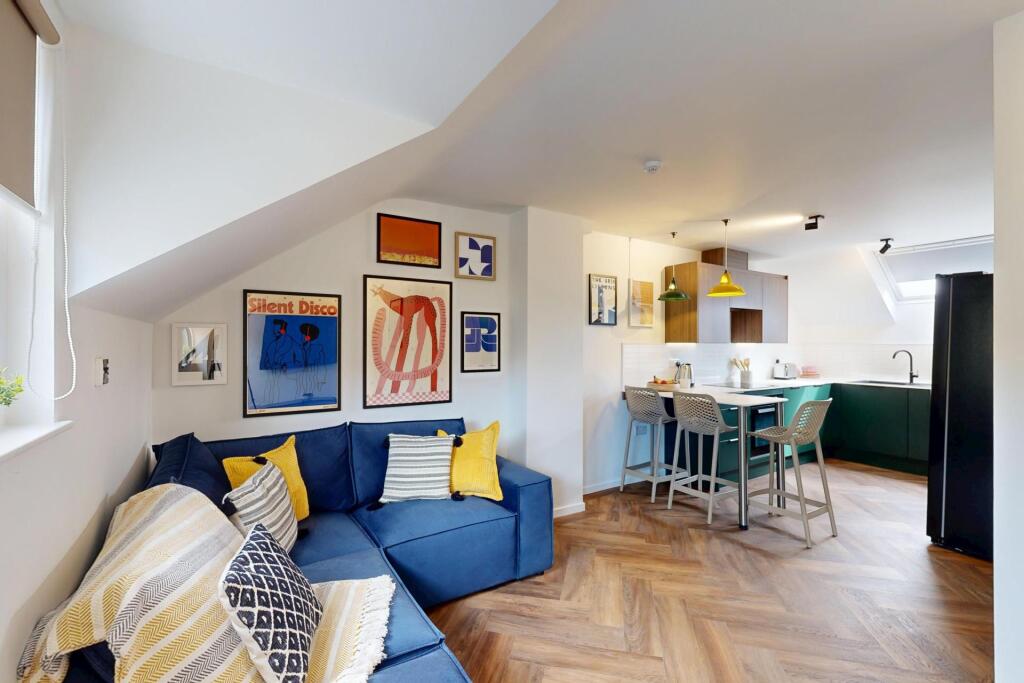 Bright, stylish open-plan living area with a co...