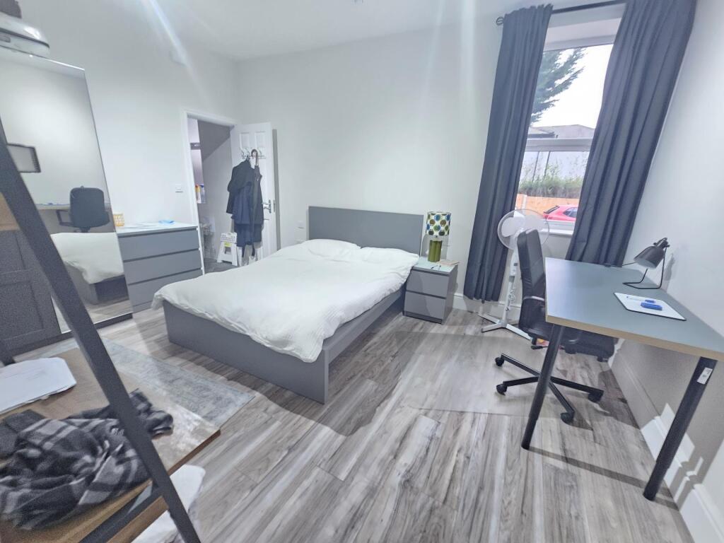 A bright and spacious master bedroom featuring ...