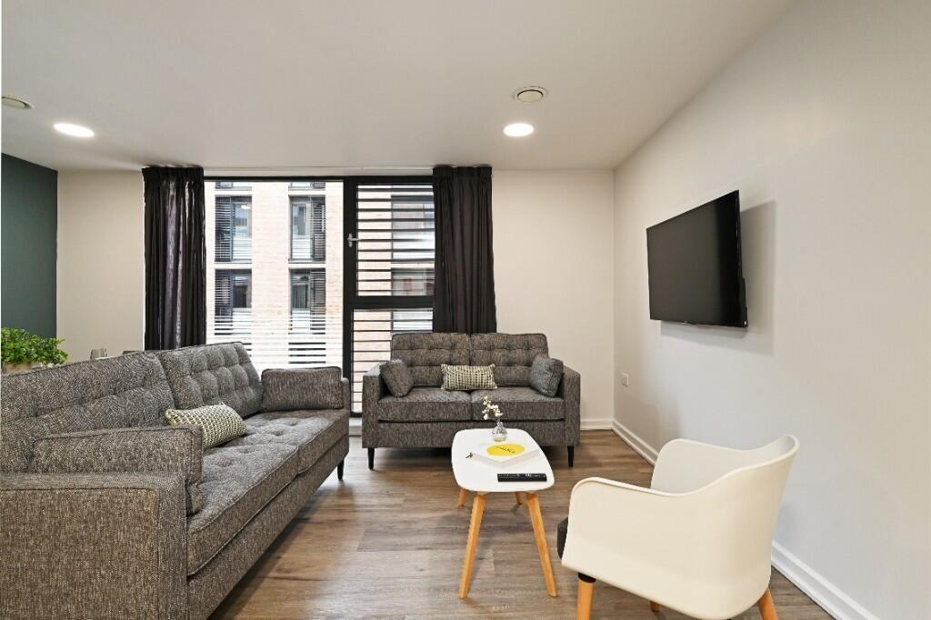 A modern and inviting living room featuring sty...