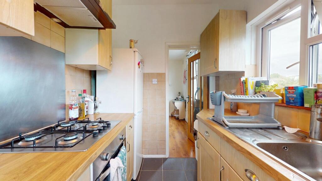 Bright and tidy kitchen featuring wooden counte...
