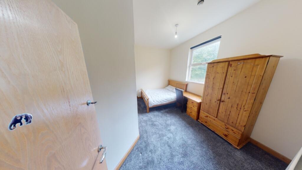 A cozy double bedroom featuring ample storage a...