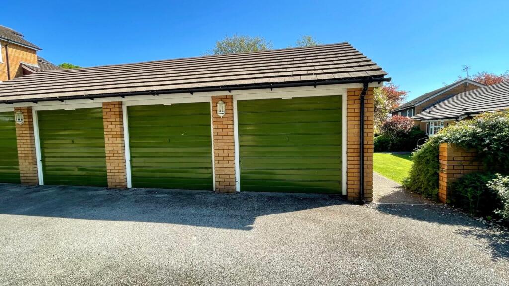The front has 2 single garages in a separate block