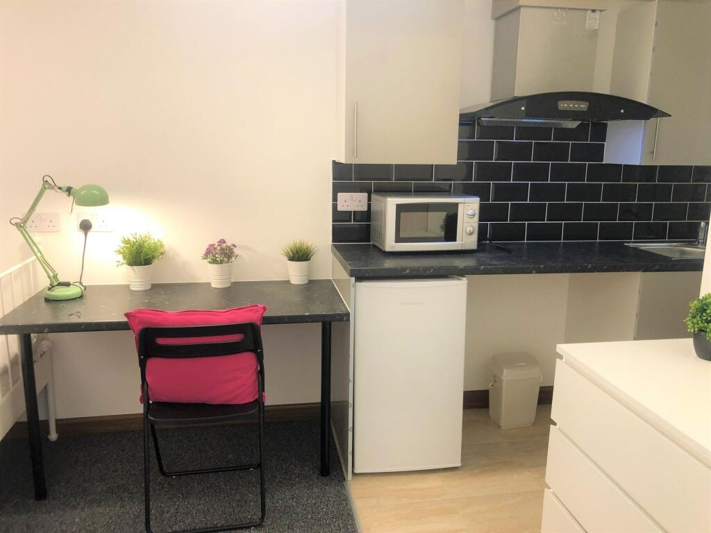 Bright and tidy kitchen space featuring modern ...