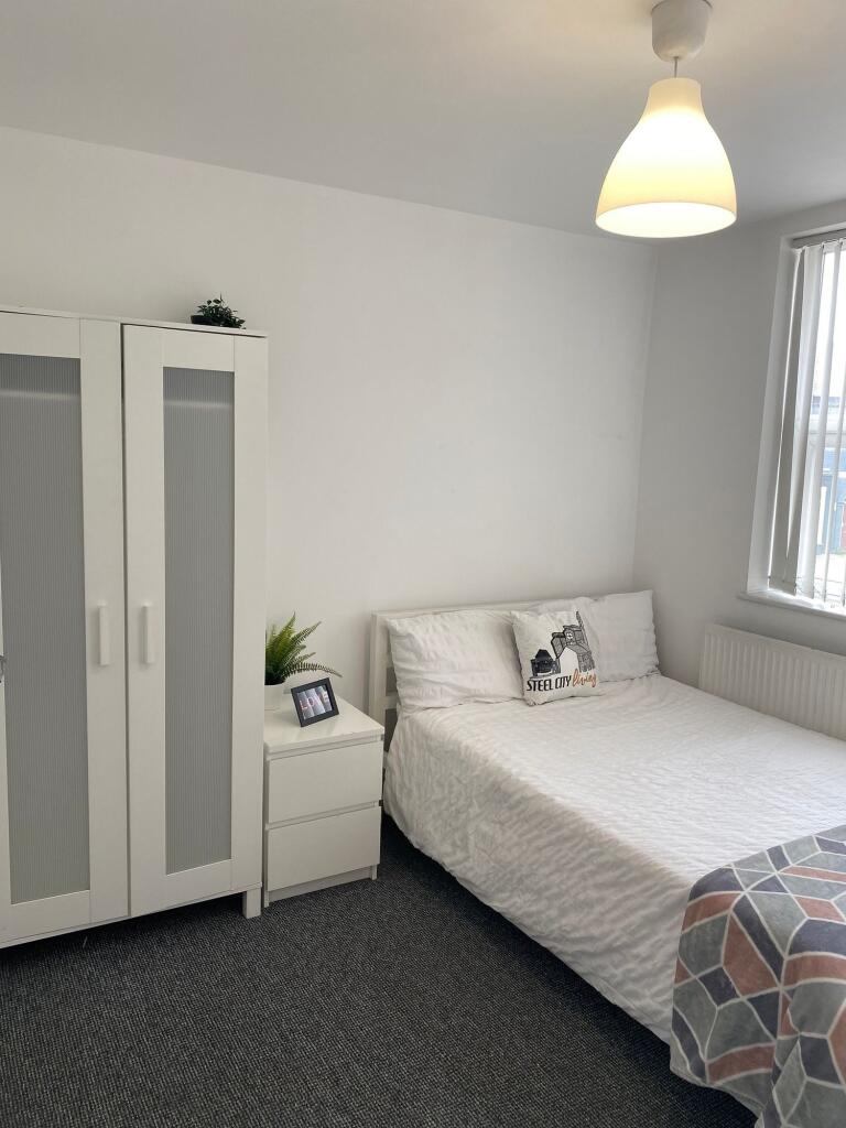 A cozy double bedroom featuring ample natural l...