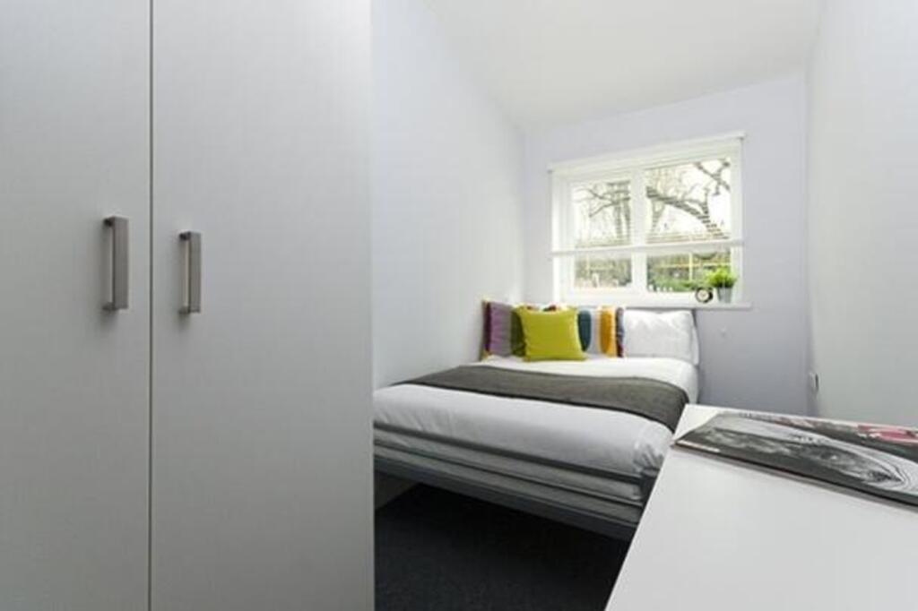 A bright and inviting double bedroom featuring ...