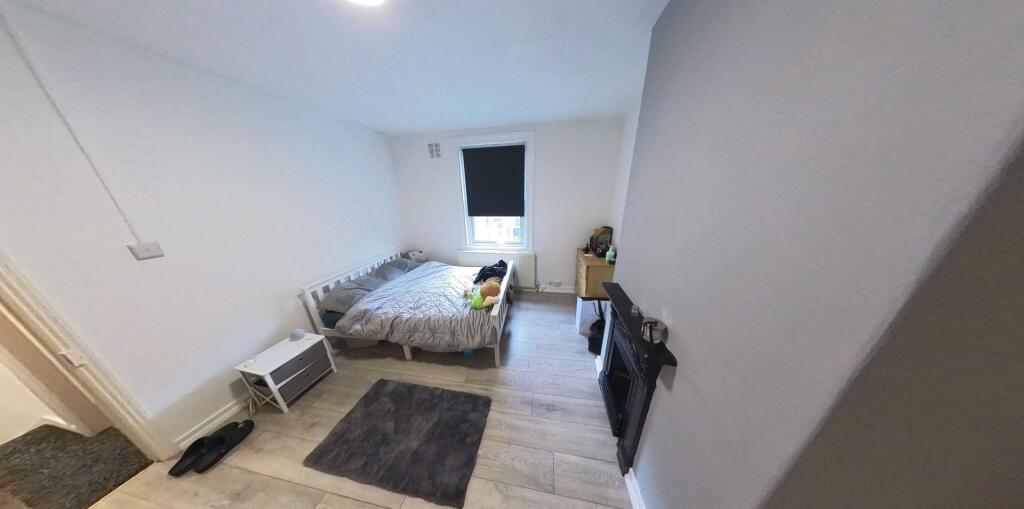 A well-maintained bedroom featuring a double be...